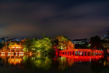 OLD QUARTER, HANOI/VIETNAM - JULY 28: Night view of The Huc bridge and Ngoc Son temple on 07 28 2018 in Lake of the Returned Sword, Lake of the Restored Sword, Hoan Kiem Lake. clipart