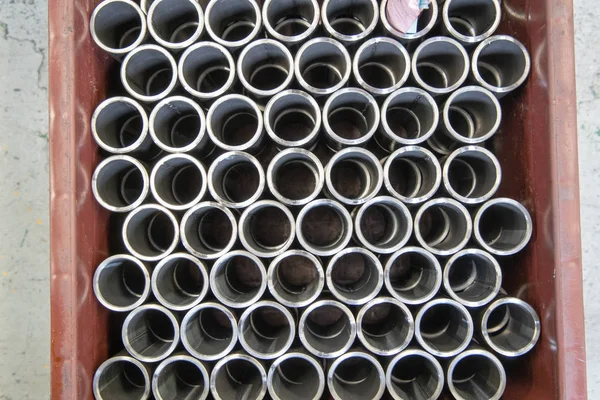 Group of steel pipes cylinder and Metal pipes for industry, construction, processing on Wooden pallets.