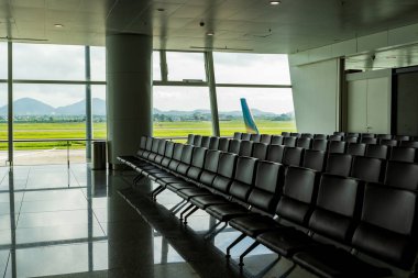 Sandalyeler, banklar, Havaalanı ve taksi yol ve pist arka plan ayrılış yolcular için kaplı koltuk bekliyor. Boş yalnız yalnız kavramı.