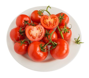 Kırmızı ripe domates şube izole beyaz arka plan üzerinde beyaz bir plaka üzerinde. Sağlıklı gıda ve vejetaryen yemek, yakın çekim, görünümü top.