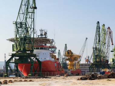 Büyük kırmızı beyaz deniz kargo gemisi liman Park. Vinç çalışma ve bir liman işlemlerinde yükleme. 