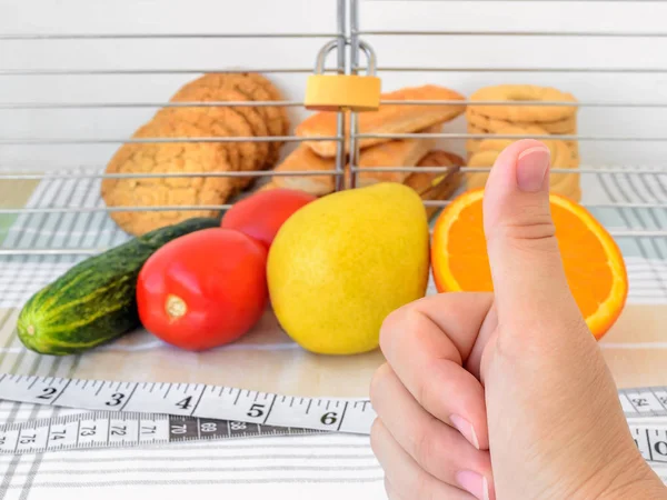 Cookies in the cage. Healthy eating and ban on junk food concept. — Stock Photo, Image