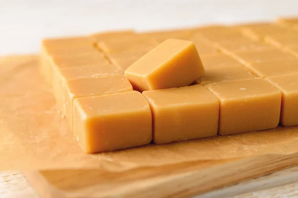 Hodně Karamelové Vanilkové Polevy Hnědém Pergamenovém Papíru Čerstvé Chutné Bonbóny — Stock fotografie