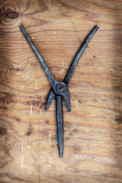 Letter with old tools on a wooden background.