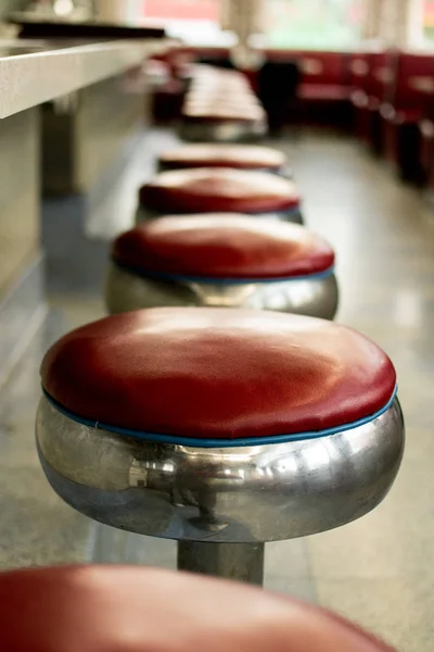 50's Style Vintage Red Leather and Chrome Bar Stools in a Diner