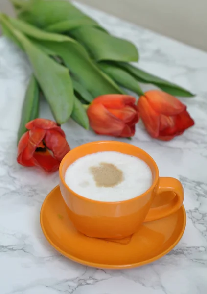 cup of coffee and beautiful tulips