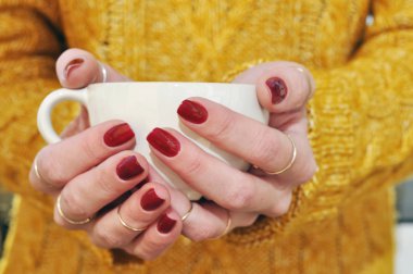 Sıcak bir içecek fincan tutan eller