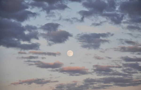 full moon and clouds over the city