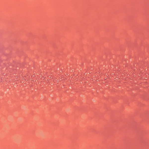 Trend photography on the theme of the color of the year 2019 - Living Coral. Sparkling abstract blurred background with beautiful bokeh effect.