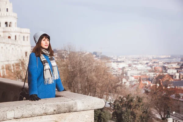 Woman looking Hungarian Parliament from the view point from Fisherman Bastion in Budapest, Hungary