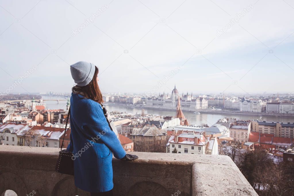 Woman looking Hungarian Parliament from the view point from Fisherman Bastion in Budapest, Hungary