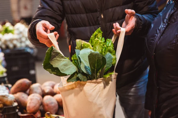 Shopping with eco shopper bag at street market, eco concept