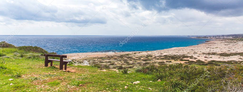 Bench stands on the seashore. Beautiful valley by the sea. Seascape in Cyprus Ayia Napa