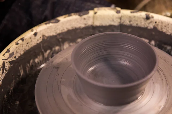 Vase from fresh clay turn twirl potters wheel. Sculptor in workshop makes jug out of clay closeup — Stock Photo, Image