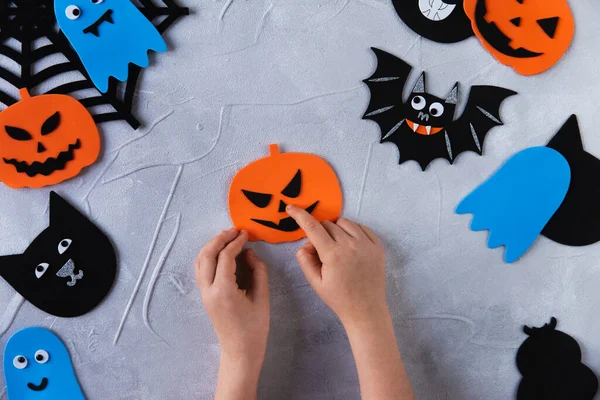 How to make decore for Halloween greetings and fun. Children art project. DIY concept. Step by step photo instruction. Step 3. Glue nose for the pumpkin