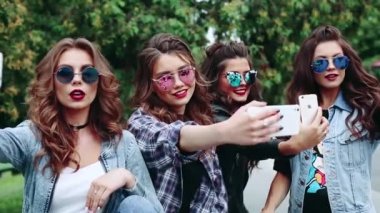 Grup güzel ve akıllı telefonlar kendi kendine portre yapmak moda esmer kızlar.
