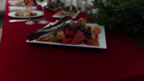 Movimiento lento del plato con frutas frescas en el restaurante, de pie sobre la mesa . — Vídeos de Stock