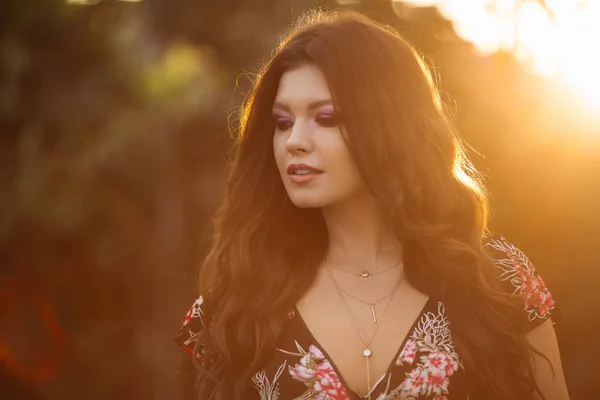 Portrait of a beautiful brunette girl with wavy.