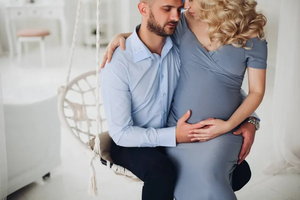 Casal lindo de mulher grávida e seu marido abraçando . — Fotografia de Stock