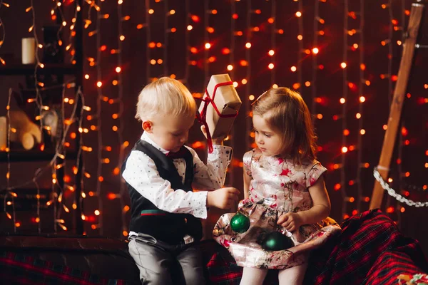 2 녹색 크리스마스 리본 장식 및 크리스마스 트리를가지고 노는 아이 들. — 스톡 사진
