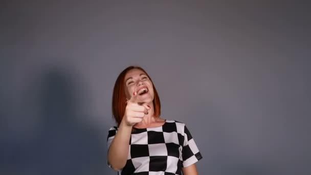 Mujer pelirroja vistiendo gestos en blanco y negro con el dedo en la cámara y sonriendo . — Vídeos de Stock