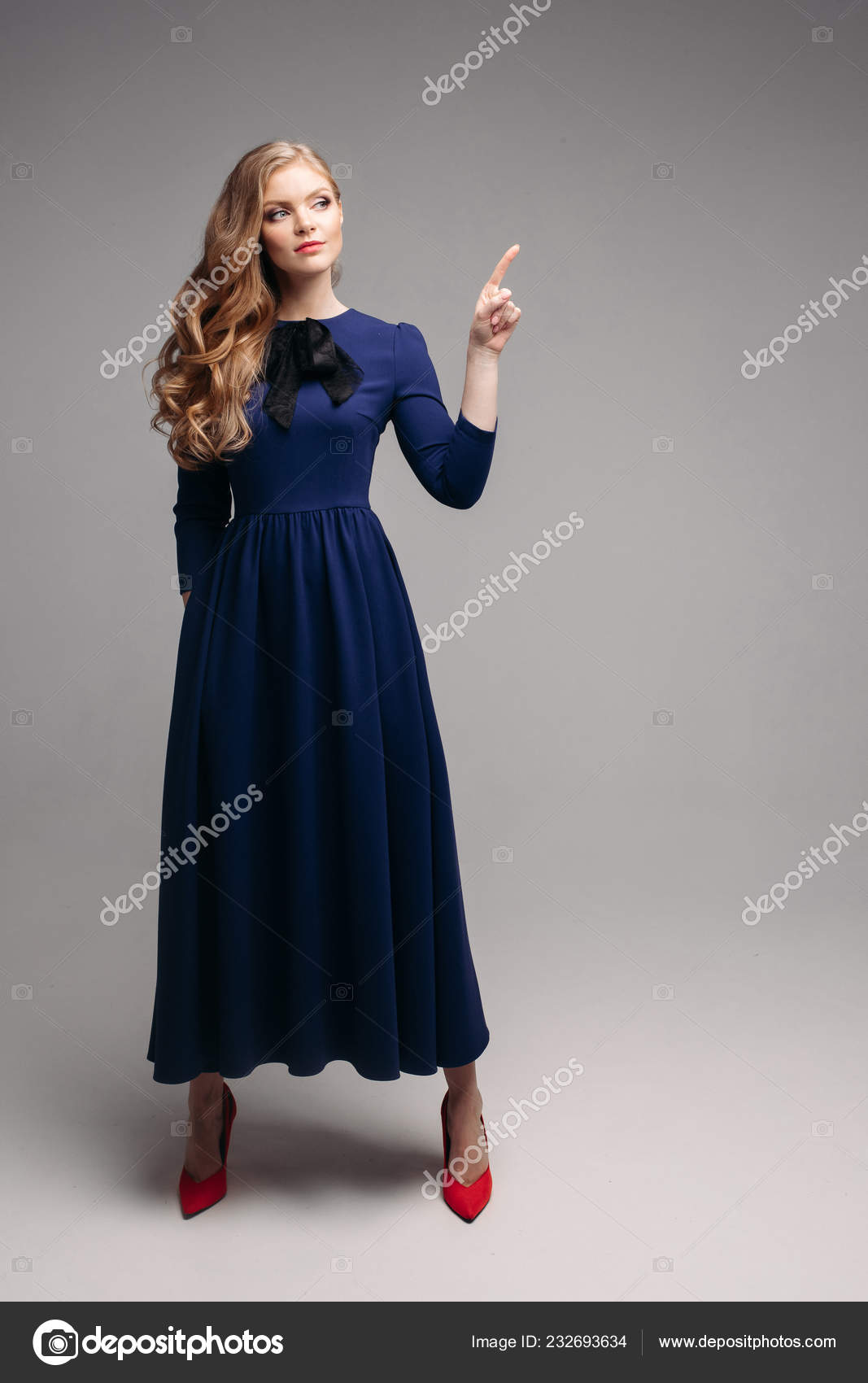 Stunning slim model in bright blue dress and black heels. Stock Photo by ©studioluckyaa 232693634