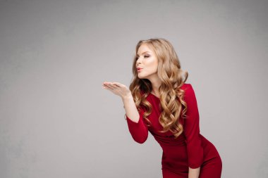 Parlak kırmızı elbise ve siyah topuklu çarpıcı ince model.