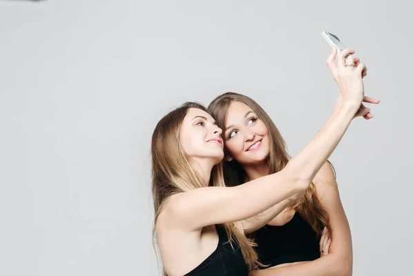 Two sporty sisters taking self portrait together. — Stock Photo, Image