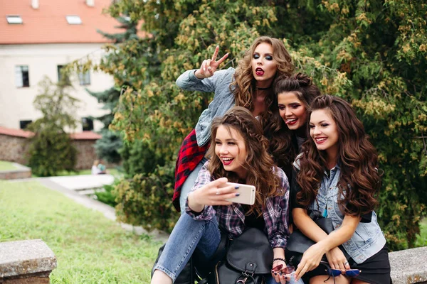 Fashionable ladies with hairstyle taking selfie outdoors. — Stock Photo, Image