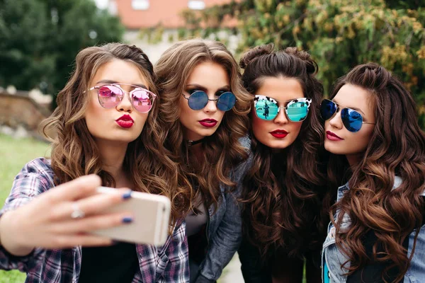 Fashionable ladies with hairstyle taking selfie outdoors. — Stock Photo, Image