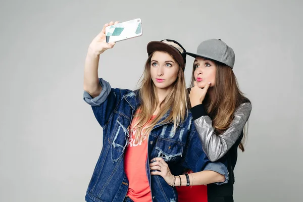 Two swag sisters taking self portrait on call phone. — Stock Photo, Image