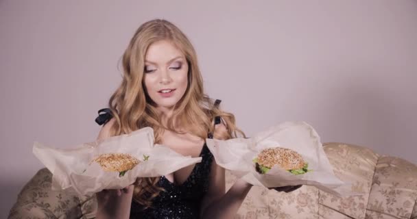 Δύο φίλες που τρώνε χάμπουργκερ. Δύο γυναίκες τρώνε πολύ νόστιμο μπιφτέκι — Αρχείο Βίντεο