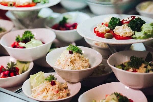 Många runda plattor med goda grönsaker skålen med sallader i restaurang. — Stockfoto