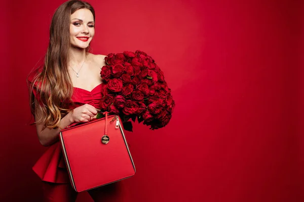 빨간 장미와 빨간 가방 빨간색으로 세련 된 화려한 갈색 머리. — 스톡 사진