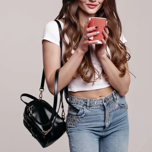 Pretty young woman in casual clothes with cup of coffee to go. — Stock Photo, Image