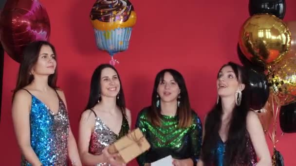 Happy four women in bright short dresses keeping gifts — Stock Video