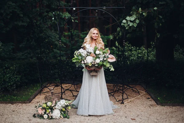 Splendida sposa bionda in perfetto abito da sposa in posa con grande boquet di nozze . — Foto Stock