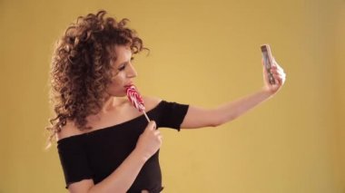Woman taking selfie and posing on camera