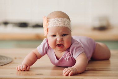 Üzgün bebek yerde yatıyor ve ağlıyor