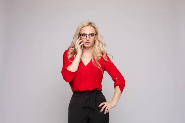 Woman in red blouse and skirt keeping phone — Stock Photo, Image