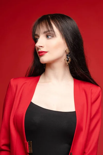 Giovane modello bruna in costume rosso in posa vicino palloncini . — Foto Stock