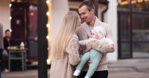 Happy family with cute baby relaxing in evening outside. — Stock Video