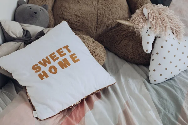 Comfortabele kussens en speelgoed van kinderen liggend op bed — Stockfoto