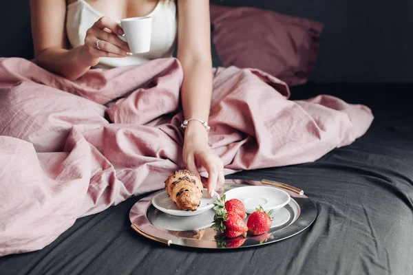 Gros plan mains féminines profitant week-end ayant appétissant petit déjeuner au lit — Photo