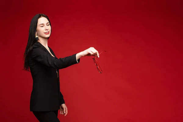 Young businesswoman thinking seriously and posing at camera.