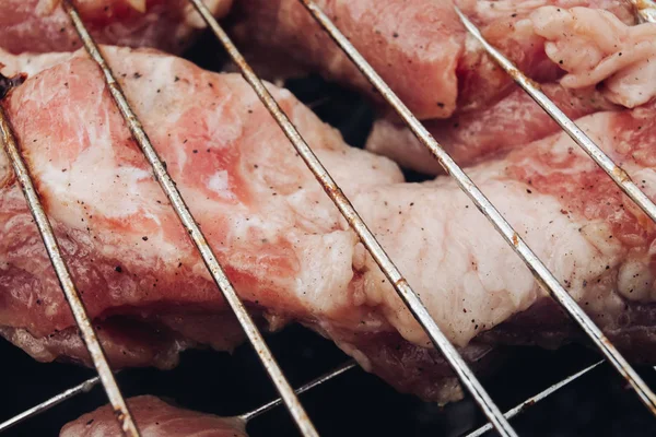 Extreme Nahaufnahme großes Stück rohes, frisches Fleisch bedeckt von würzigem Pfefferduft auf dem Grill — Stockfoto