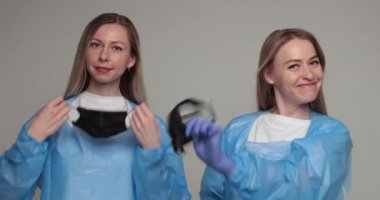 İki doktor koruma üniformalarını çıkarıyor..