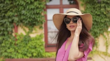 Güzel, mutlu genç bir kadın yazın şehrin sokaklarında yürüyüşe çıktı.