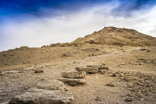 HDR desert ground and stones with dramatic skies with copy space