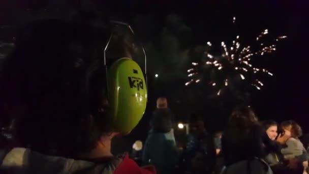 Boy with ear noise protection covers at fireworks party shot — Stock video